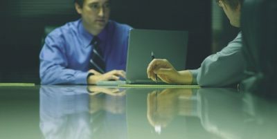men-dicussing-at-desk---small2